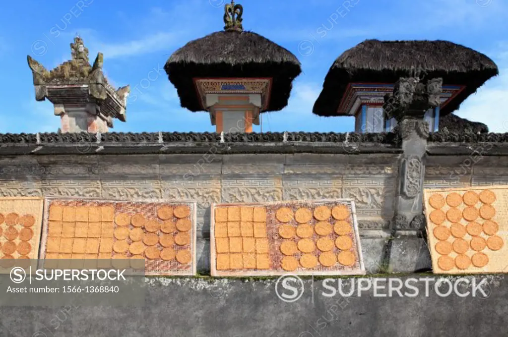 Trays of Rice Cakes drying on a temple wall, near Ubud. Bali, Indonesia.