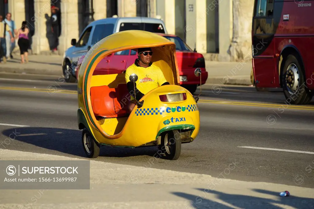 A speeding Coco motorcycle taxi in the street of Havana, Cuba.