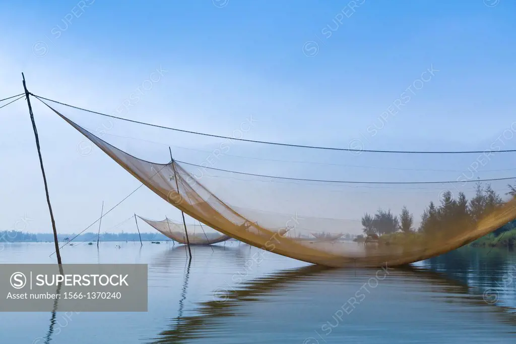 Large fishing nets in the Thu Bon River near Hoi An, Vietnam, Asia.