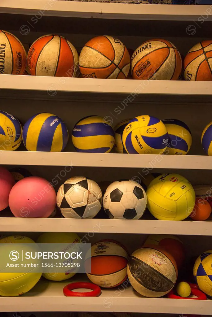 collection of balls at sports court at a highschool