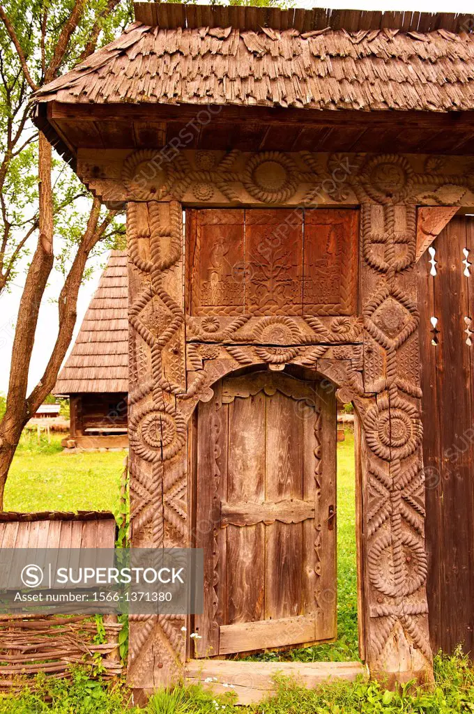 19th century traditional Iza Valley farm house carved wooden folk art gates, The Village museum near Sighlet, Maramures, Northern Transylvania.
