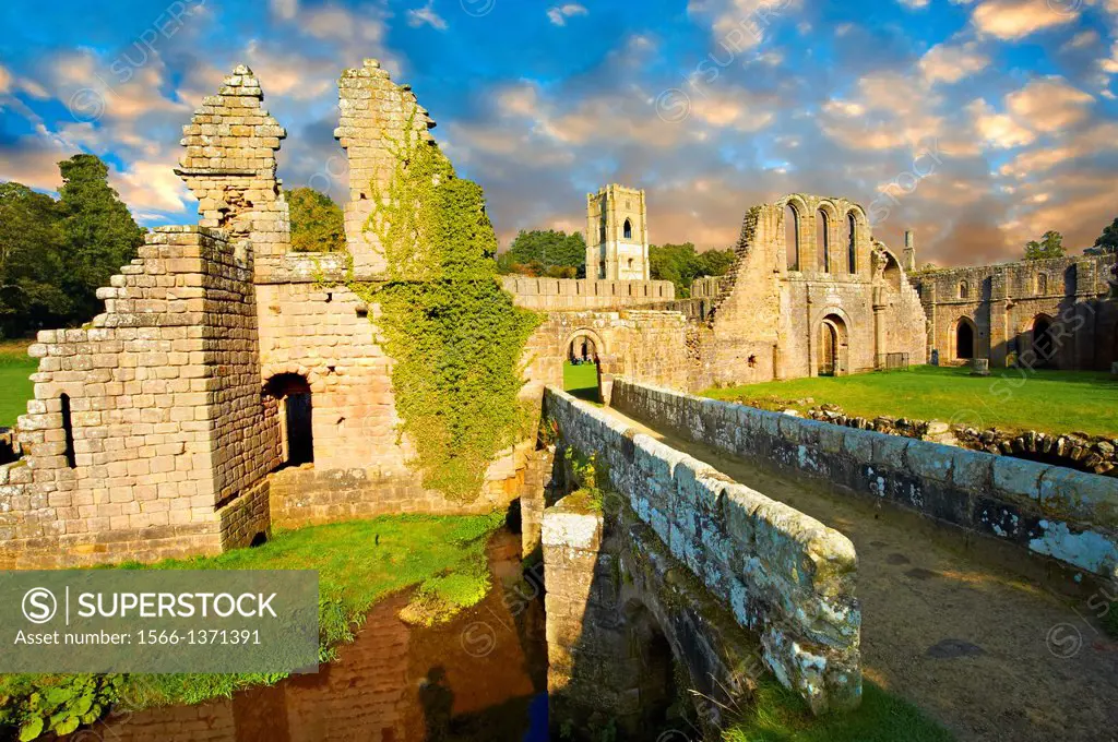 Entrance at sunrise of the ruins of Fountains Abbey , founded in 1132, is one of the largest and best preserved ruined Cistercian monasteries in Engla...