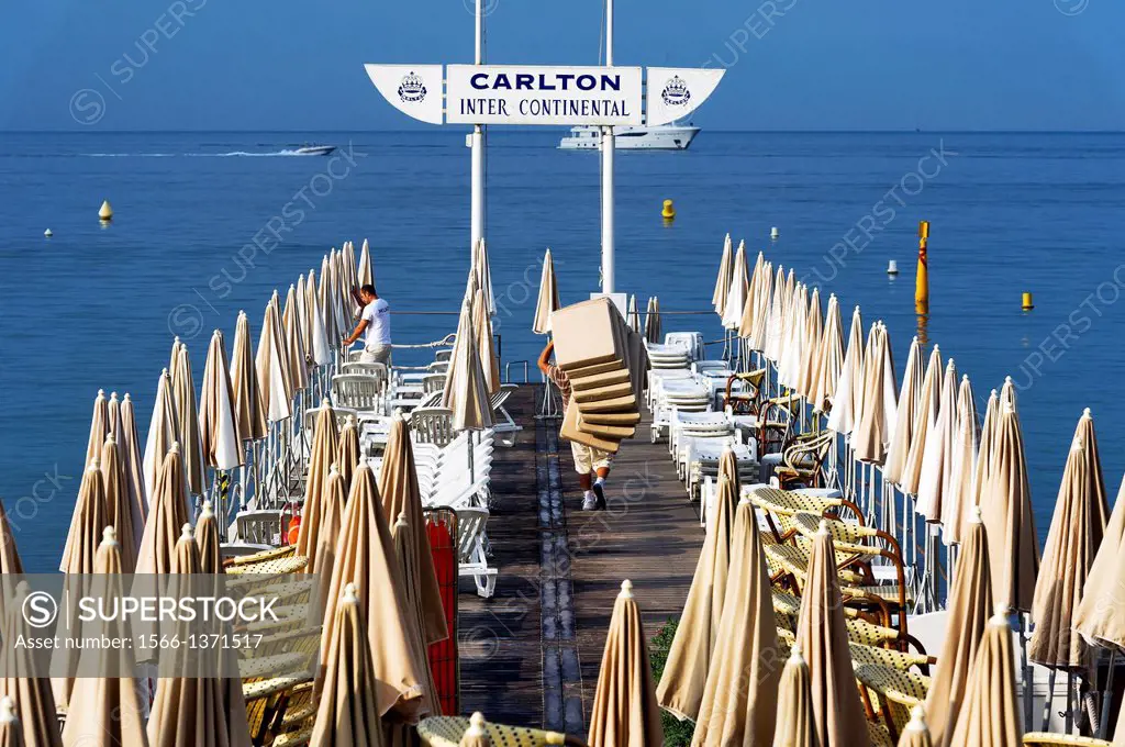 Europe, France, Alpes-Maritimes, Cannes. Beach attendant at Carlton Palace Hotel.