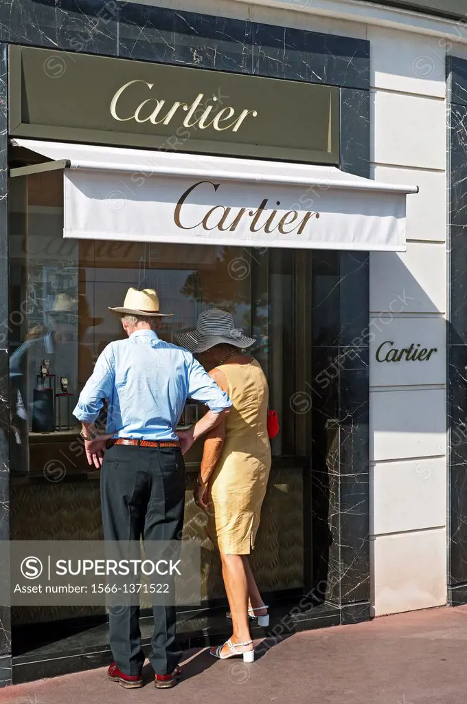 Europe, France, Alpes-Maritimes, Cannes. Couple in front of window of Luxury jewelry store.