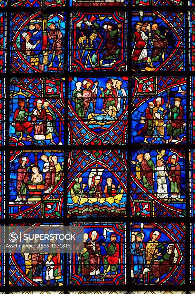 Medieval stained glass Window of the Gothic Cathedral of Chartres, France - dedicated to The life of St Apollinarie. Stained glass panels from bottom ...