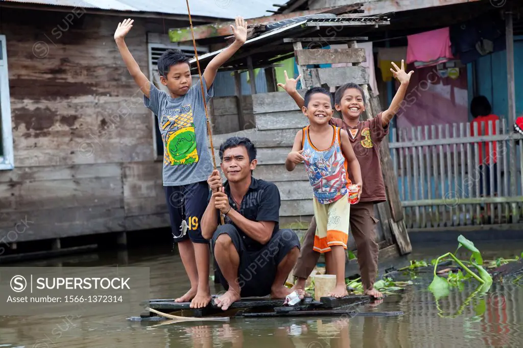Joyful Children at a Canal in Banjarmasin, Indonesia.