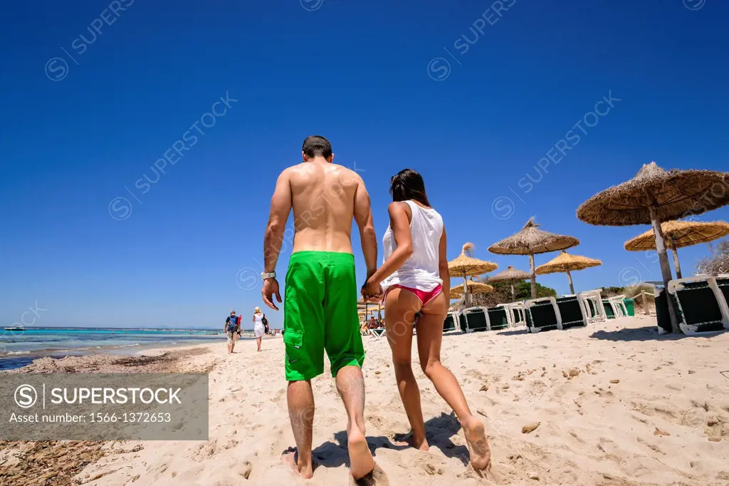 couple walking on the beach, beach Es Trenc. Mallorca. Balearic Islands. Spain.
