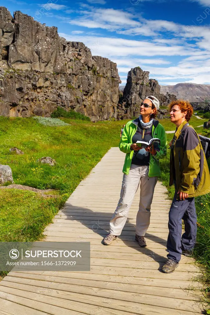 women in Rift Valley. Pingvellir National Park. Golden Circle. Iceland, Europe.