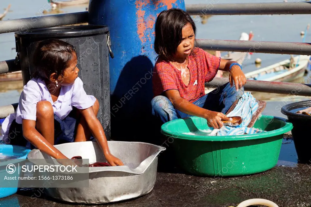 Little Sea Gypsy Girls doing the Laundry on Rawai Beach on Phuket, Thailand