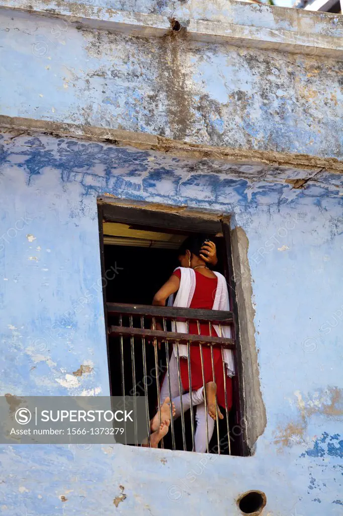 Woman leaning in a Window in Varanasi, India