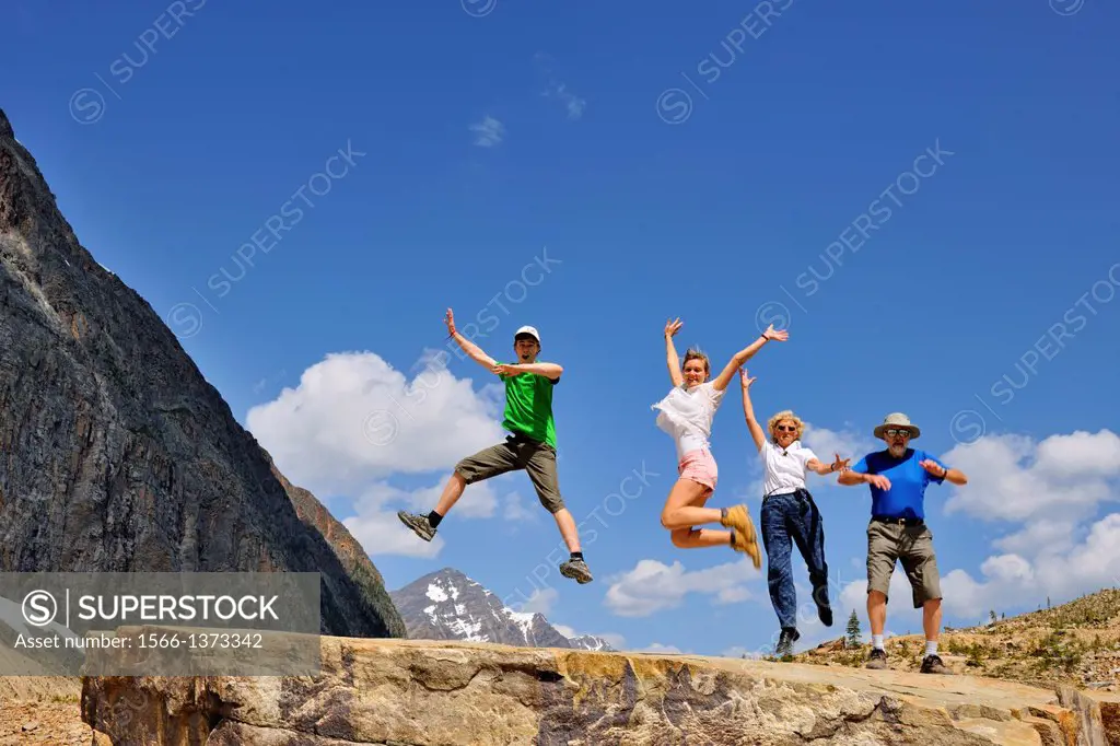 Tourists frolicking below Mt. Edith Cavell, Jasper National Park, Alberta, Canada.