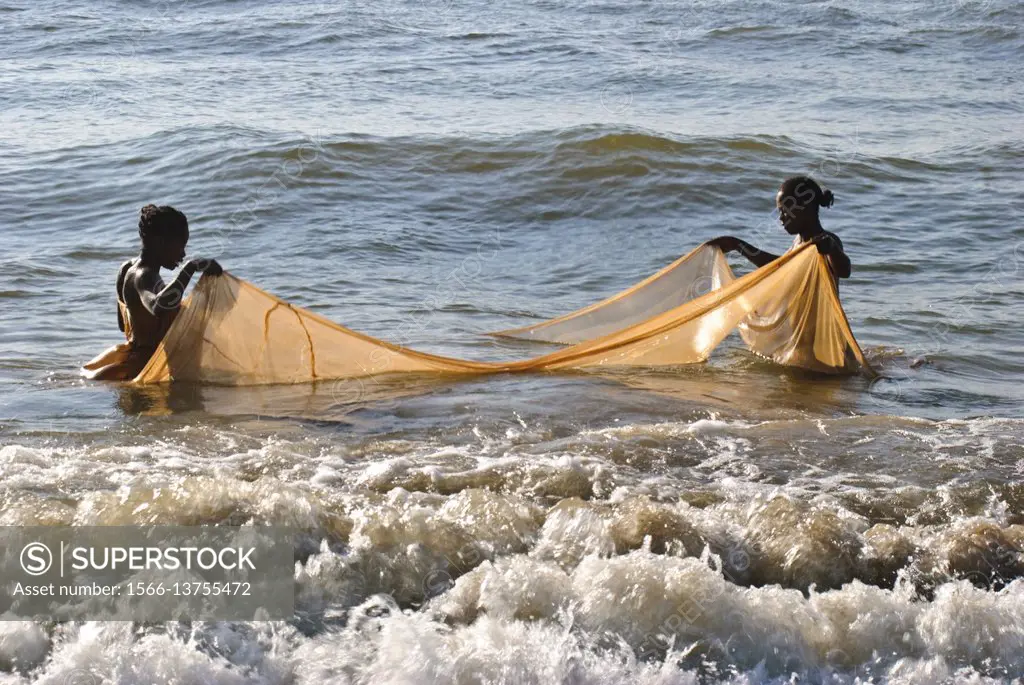 Two women are fishing ´´bichiques´´. Near Mananjary ( Madagascar). ´´Bichiques´´ are fry of two species of freshwater fish belonging to the ´´gobiidae...