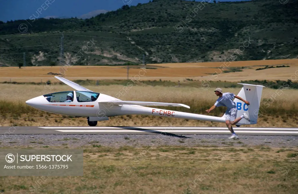 Glider plane ASH-25 taking off on runway, Santa Cilia de Jaca aerodrome, Aragon, Spain.