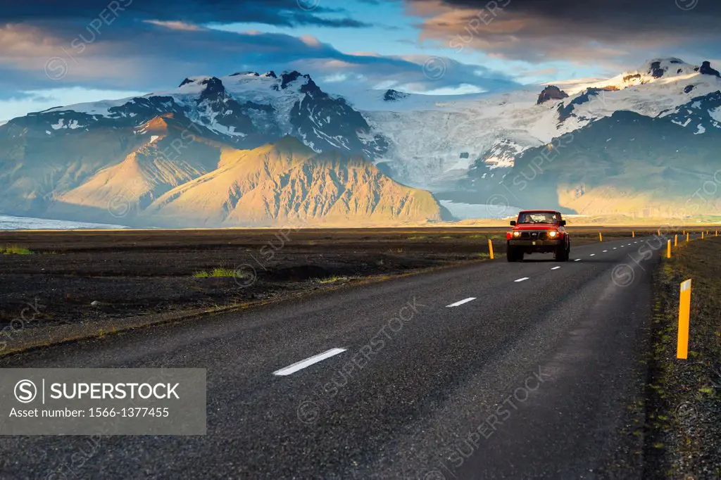 4WD vehicle crossing a mountain landscape in south Iceland, Europe.