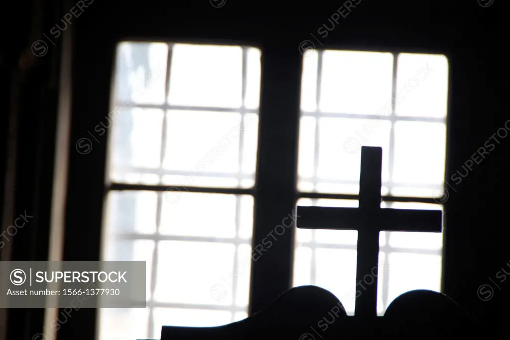 cross on top of confessional box in church in rome italy.