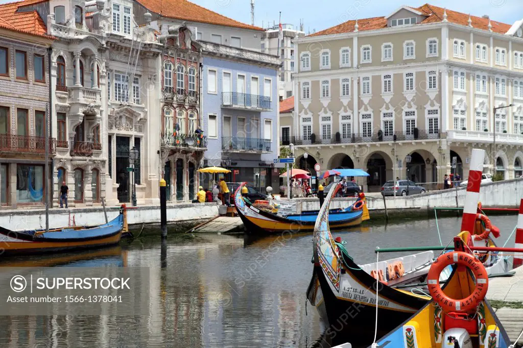 Portugal, Aveiro. Moliceiro boats docked by Art Nouveau style buildings along the central canal.