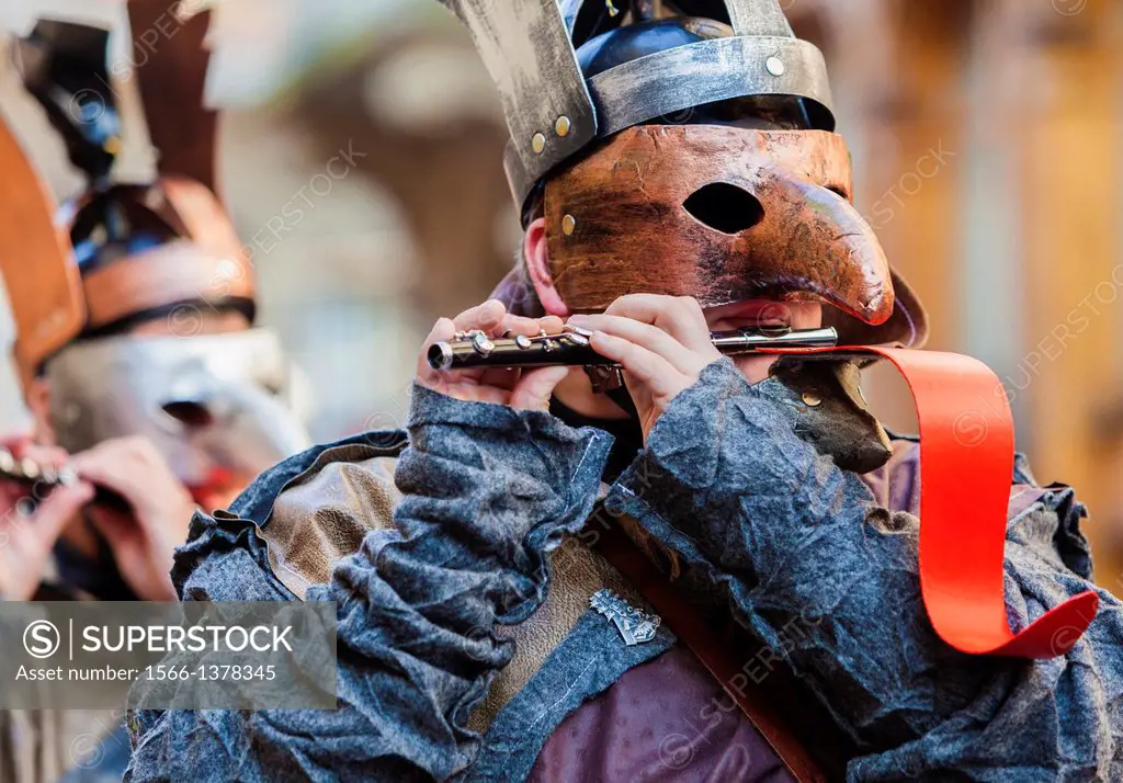 Costumed musicians in a parade playing traditional Carnival (Fastnacht) music in Basel, Switzerland.