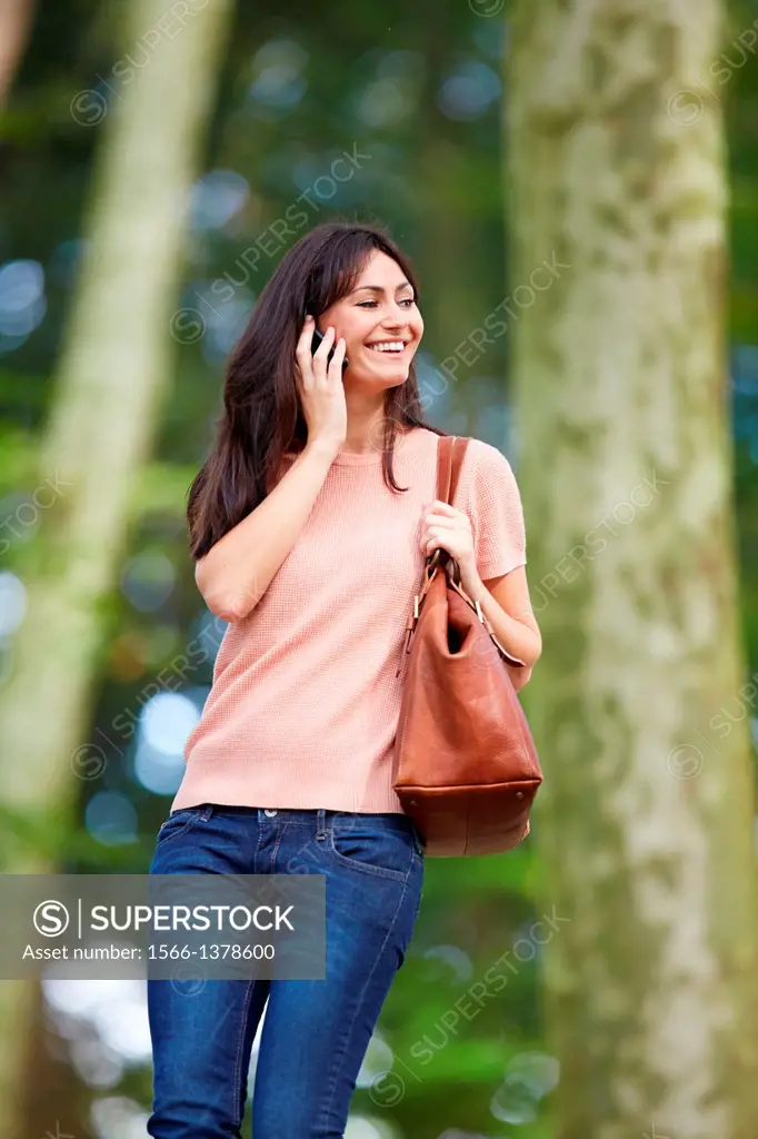 35 year old woman in park talking with smartphone. Donostia. San Sebastian. Gipuzkoa. Basque Country- Spain.