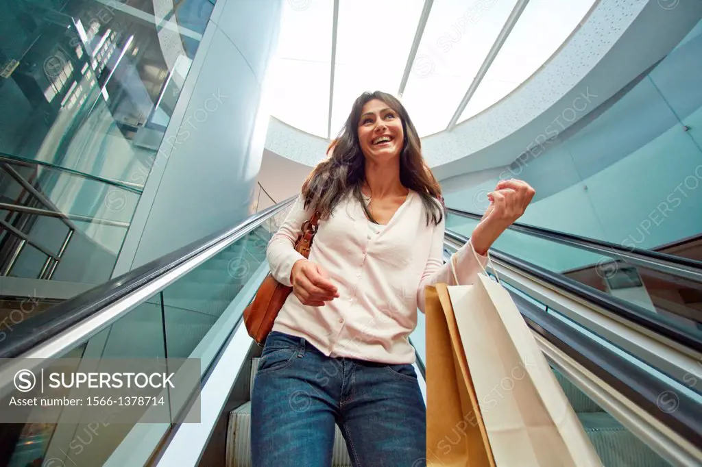 35 year old woman on escalators. Shopping at the Bretxa Market. Donostia. San Sebastian. Gipuzkoa. Basque Country. Spain.