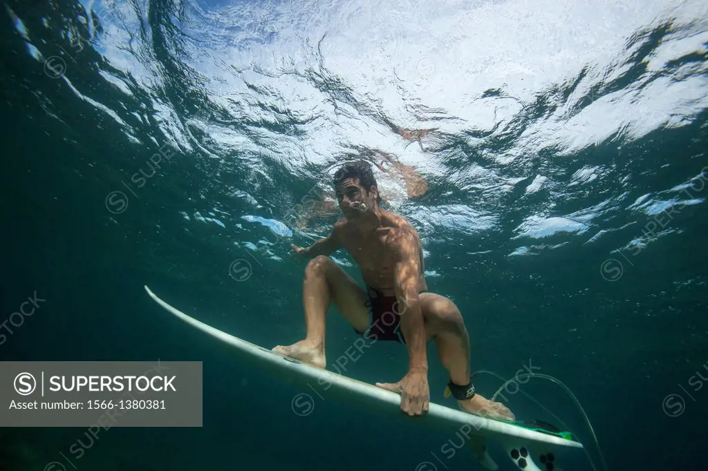 guy surfing under water.