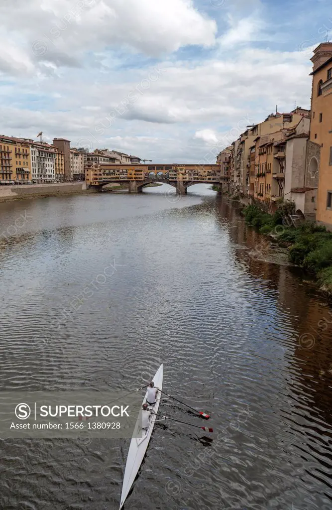 Firenze,Tuscany,Italy,Europe.Canoe over arno river with ponte vecchio at background.