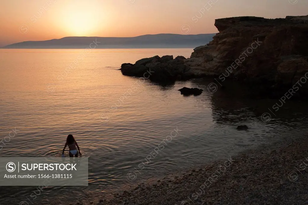 Woman in bikini going to have a swim, Koufonissi, Cyclades Islands, Greek Islands, Greece, Europe.