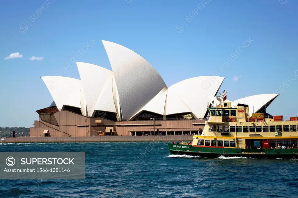 sydney ferry passing in front of opera house.