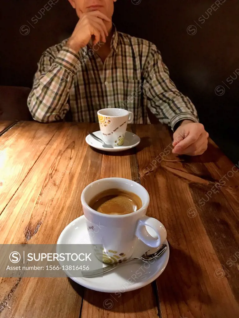 Man thinking and drinking a cup of coffee.