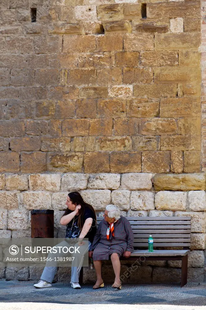 Man and old Woman on a Bench in Cole di Val d'Elsa in Tuscany, Italy.
