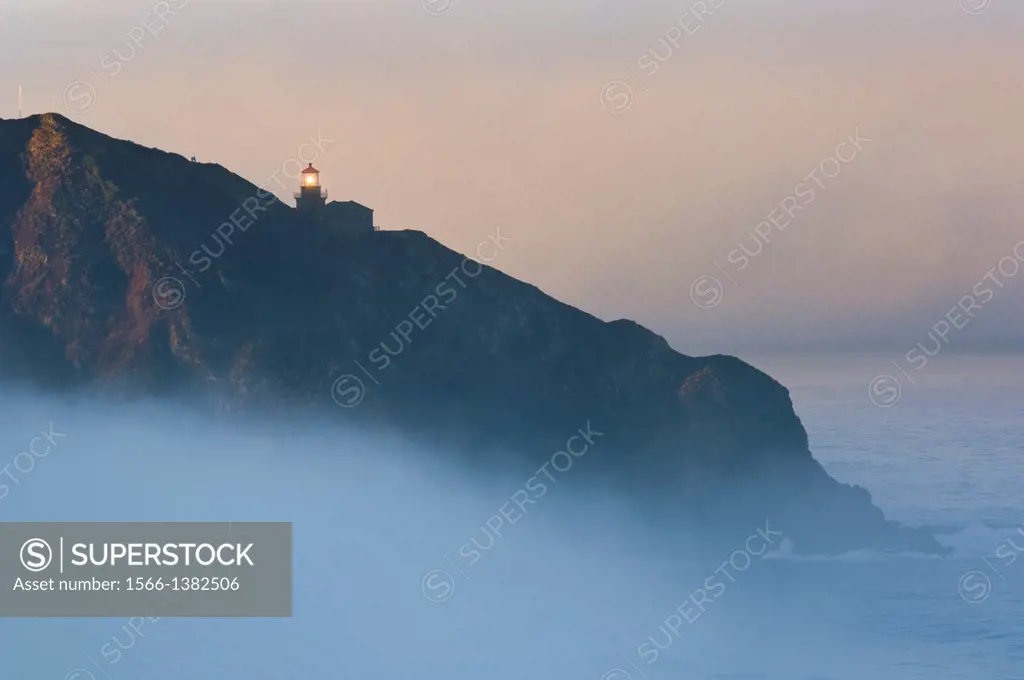 Point Sur Lighthouse and morning fog at sunrise, Big Sur, Monterey County coast, California.