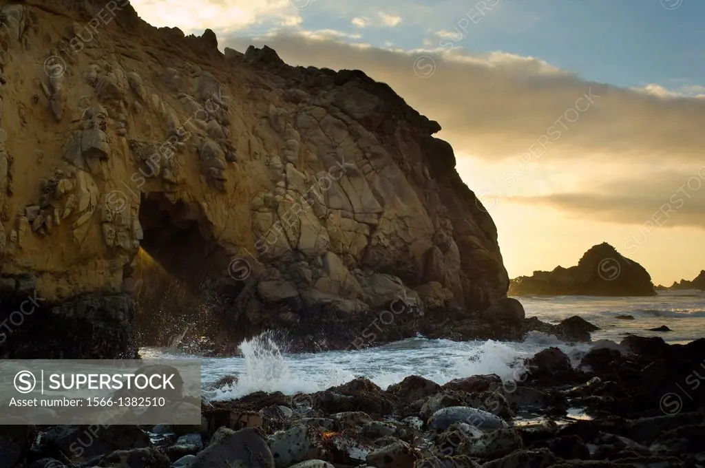 Sunset and coastal rock at Pfeiffer Beach, Big Sur, California.
