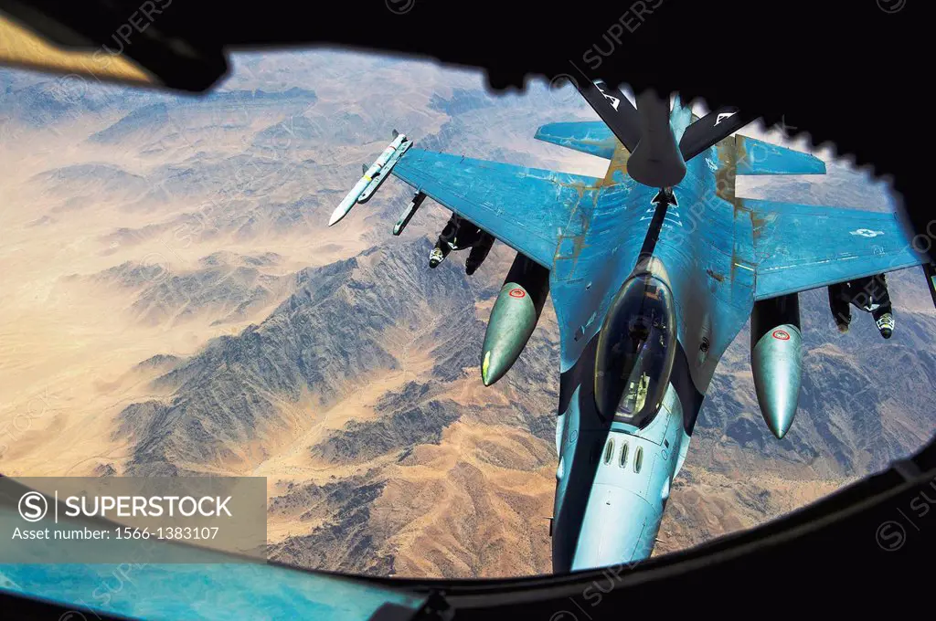 An F-16 Fighting Falcon receives fuel during an in-air refueling mission July 17, 2013, over Afghanistan. The fuel was provided by a KC-135 Stratotank...