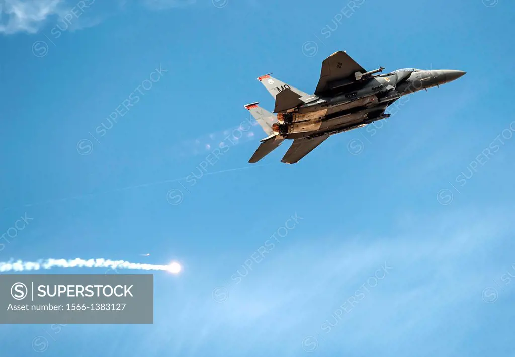 An F-15E Strike Eagle pops defensive flares and pulls up after a close-air support mission during exercise Mountain Roundup 2013, Oct. 16, 2013, at Sa...