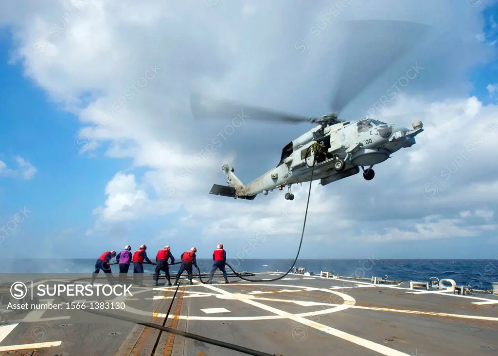 SOUTH CHINA SEA (Oct. 20, 2013) Sailors refuel an MH-60R Sea Hawk helicopter from the Warlords of Helicopter Maritime Strike Squadron (HSM) 51 aboard ...