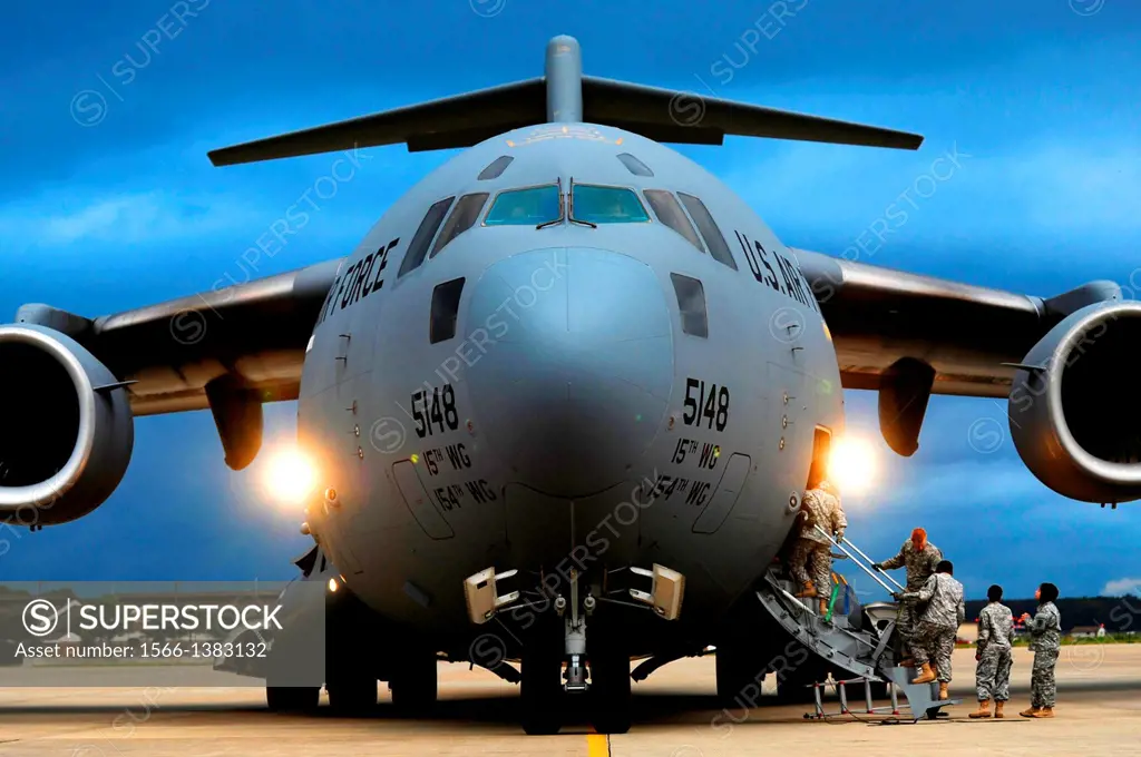 Army Soldiers board a C-17 Globemaster III during an unloading mission Oct. 23, 2013, at Langley Air Force Base, Va. The Soldiers partnered with Airme...