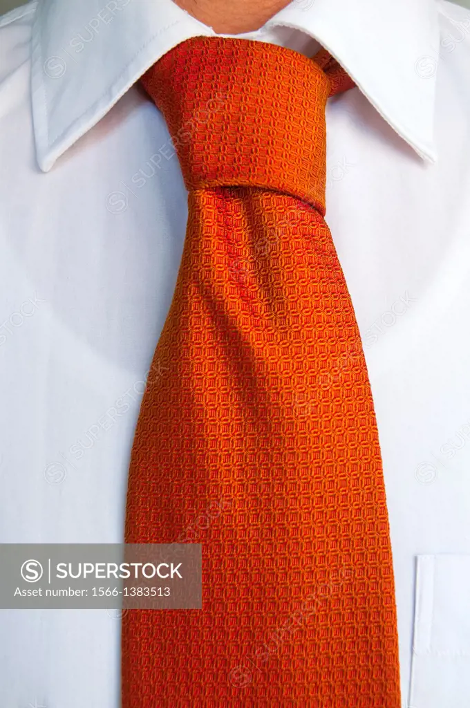 Orange tie on white shirt. Close view.