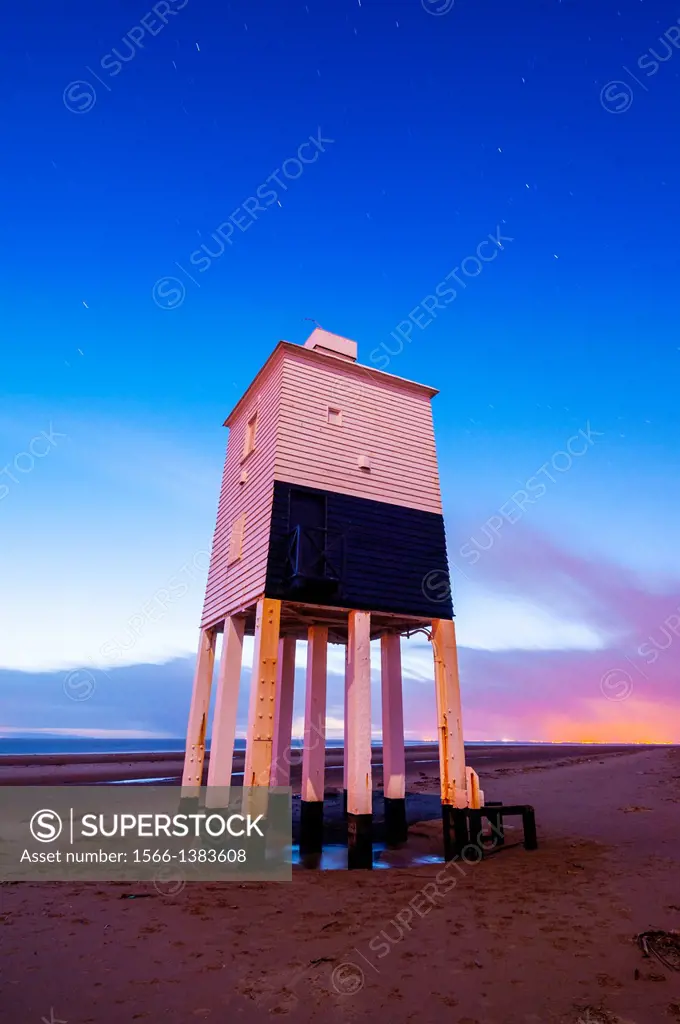 The wooden lighthouse at Burnham-on-Sea overlooking Bridgwater Bay at Dusk, Somerset, England, United Kingdom. Short star trails are visible in the sk...