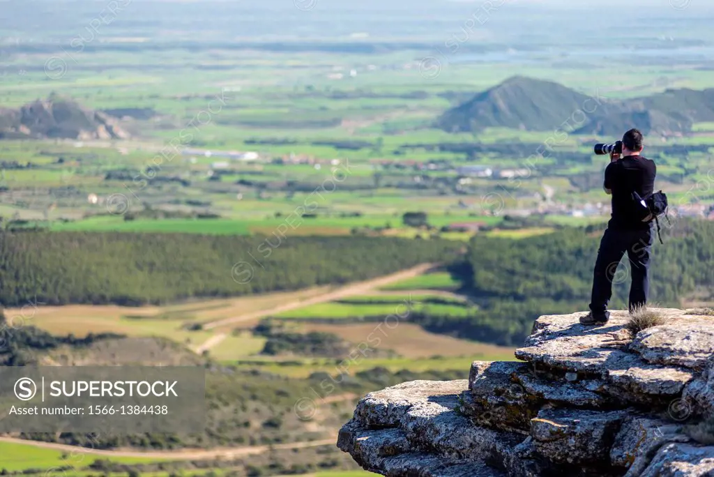 Photographer shotting Panoramic views from Mallos de Riglos hill, Hoya de Huesca, Aragon, Spain.