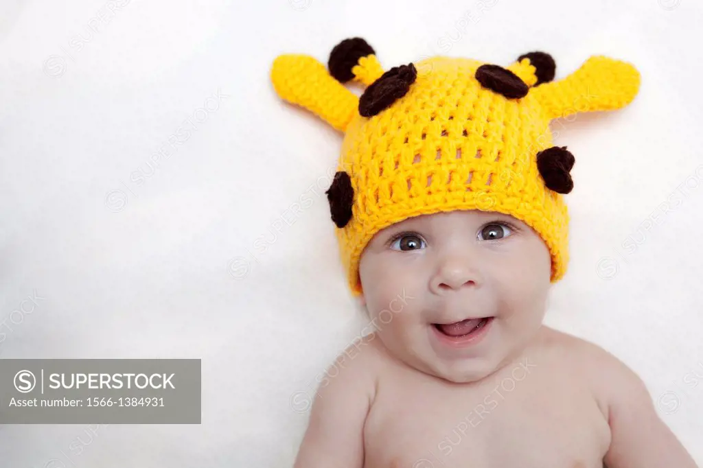 Baby girl in giraffe hat.