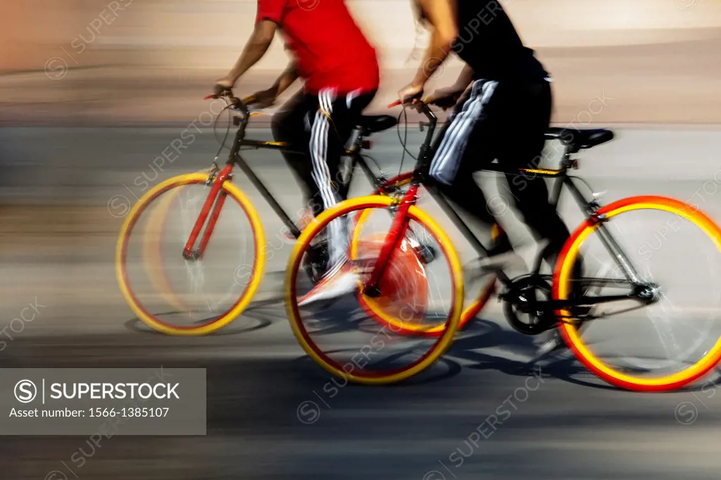 Two cyclists in motion, San Jose, California, USA