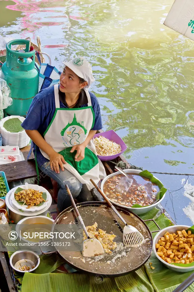Sale of Food on a Boat on the floating Market of Taling Chan in Bangkok, Thailand.