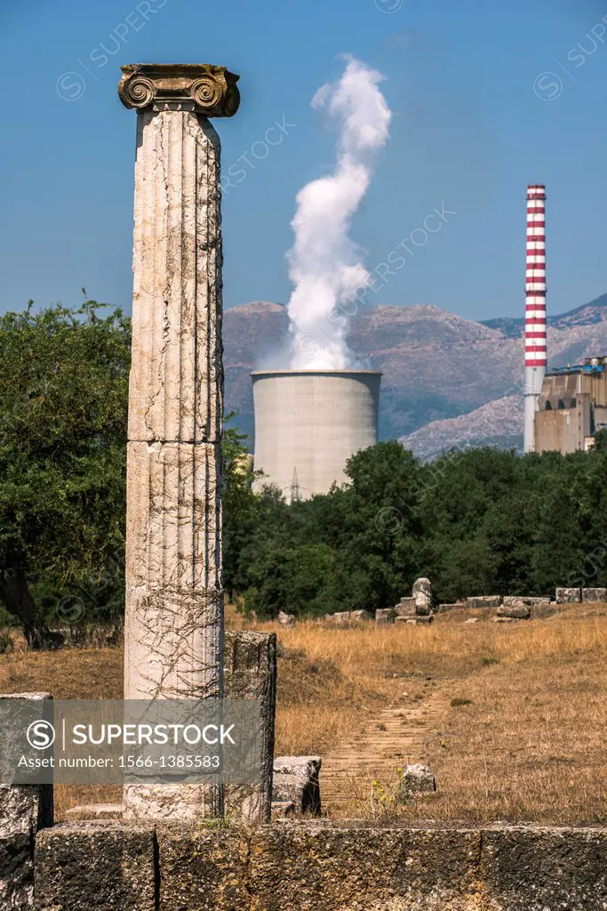 An ionic column from the ruins of Ancient Megalopolis with the cooling tower and chimney of Mergalopolis modern power station in the background. Centr...