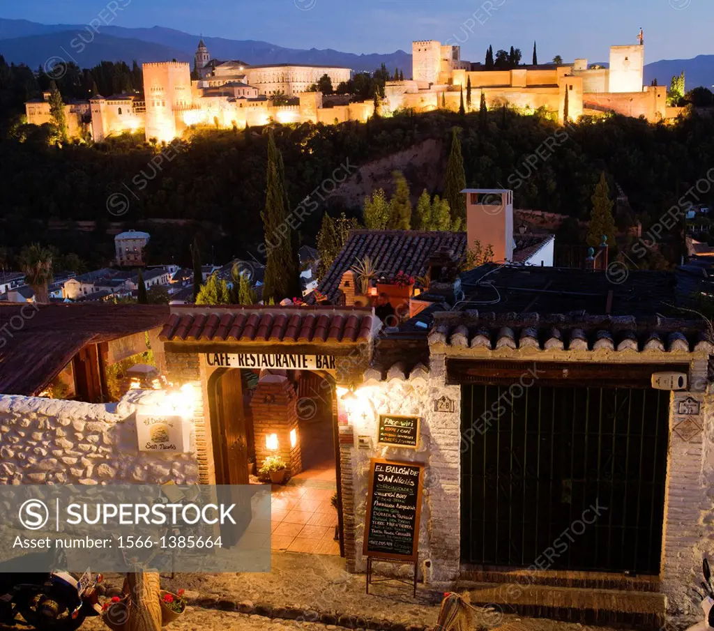 Restaurant, on background The Alhambra Palace from Mirador of San Nicolas in the Albayzin or Albaicín quarter, Granada, Andalusia, Spain, Europe.