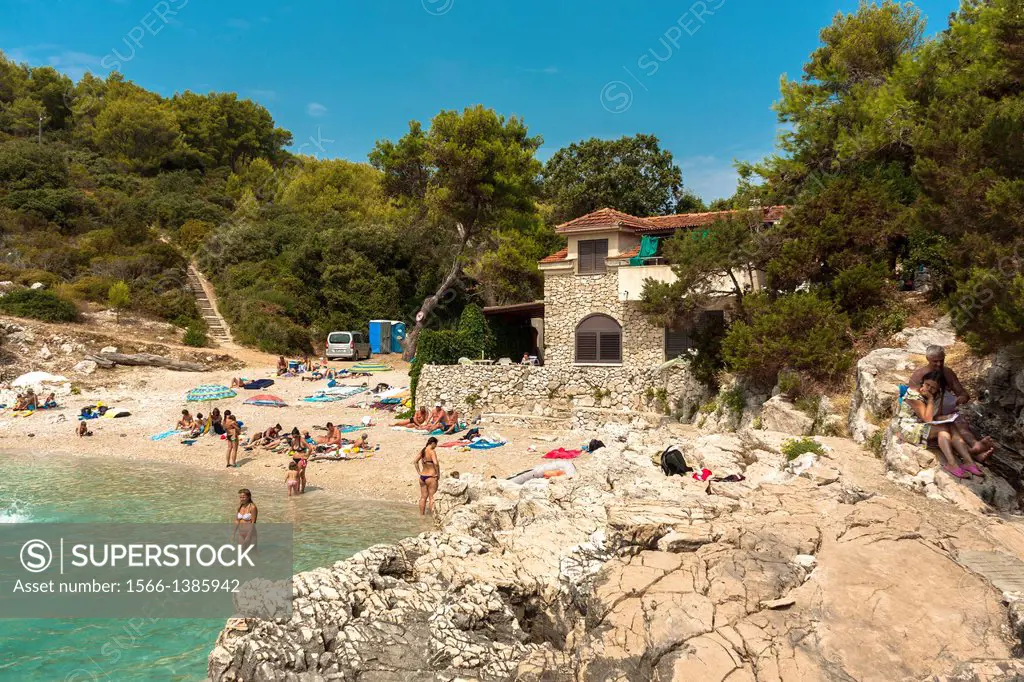 People relaxing at Zitna beach near Zavalatica, Croatia.