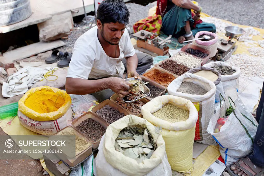 Merchant selling spices, Bhil market, Jhabua, Madhya Pradesh, India.