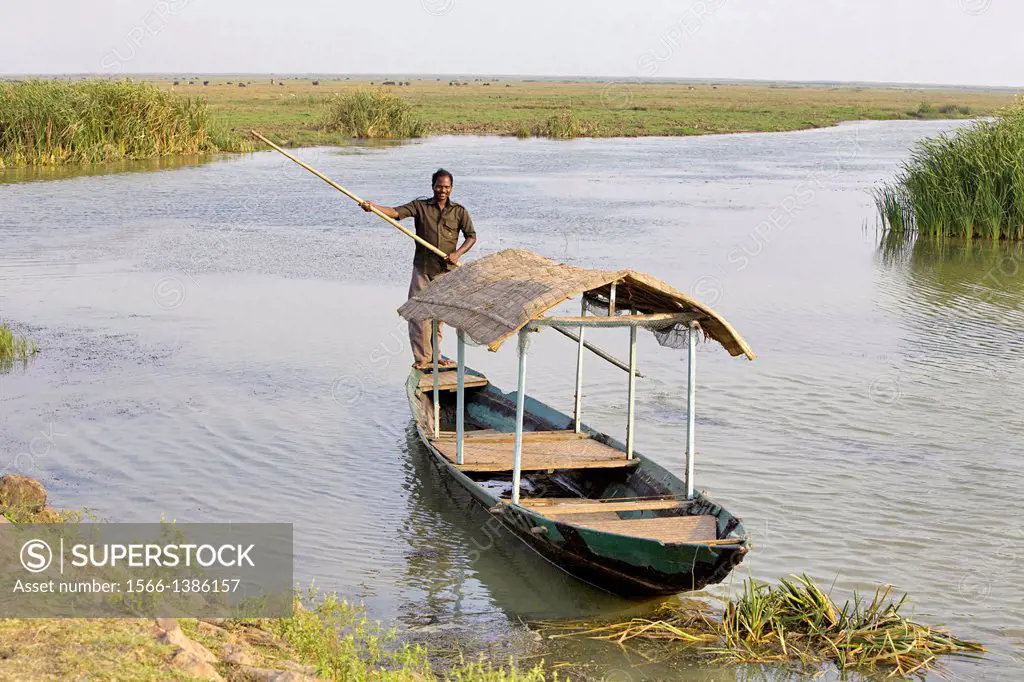 A tribal house boat and boatman, Chilika Lake, Orissa, India.