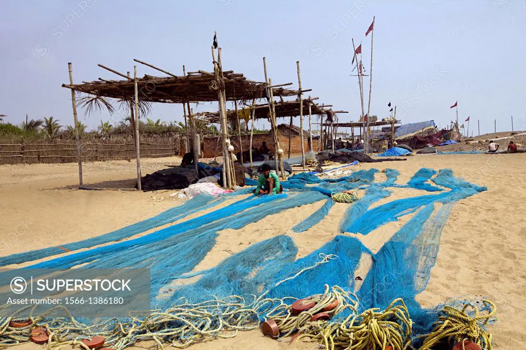 Fishermen making fishing nets, Orissa, India.