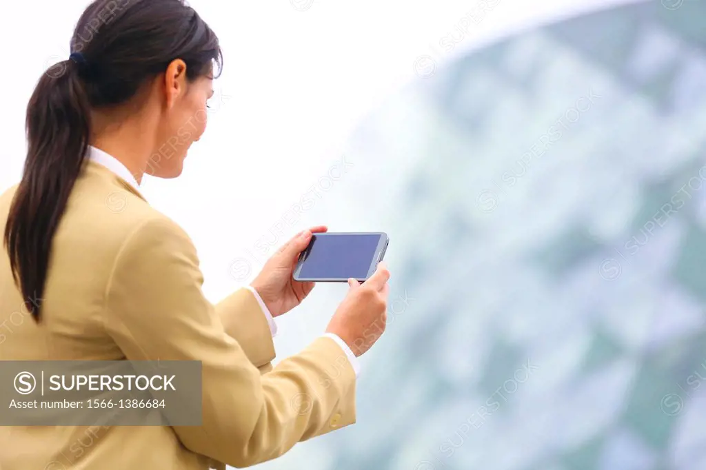 Business woman with smartphone in business center. San Sebastian Technology Park. Donostia. Gipuzkoa. Basque Country. Spain.