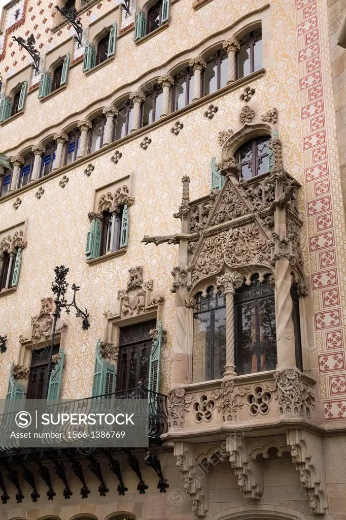 Balconies and windows on an old architectural building facade, Barcelona, Spain.