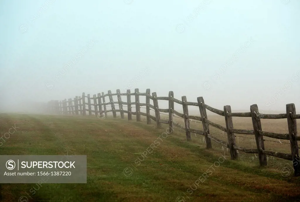 Wooden farm fence on a foggy morning, Connecticut, USA.